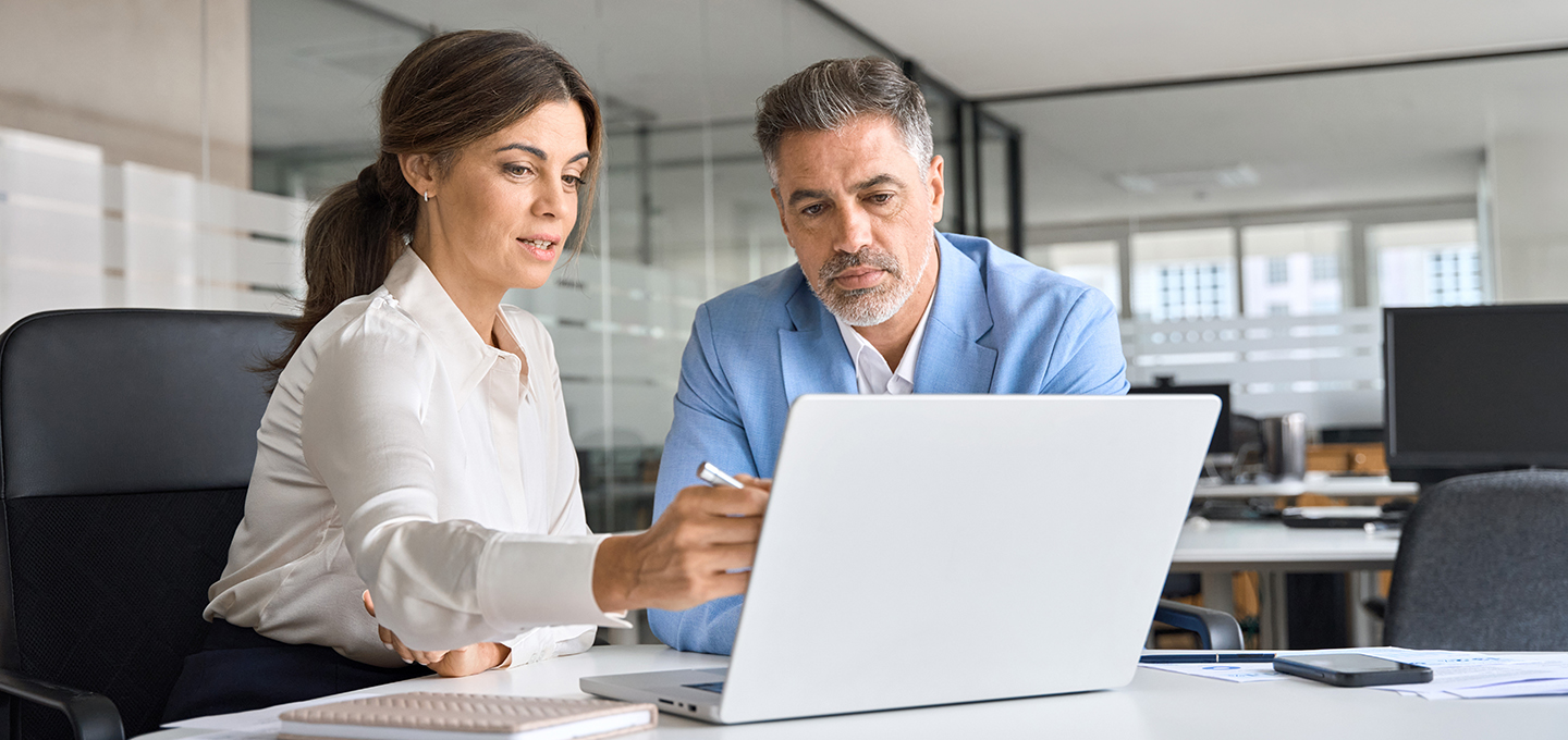 Man and woman looking at a laptop screen