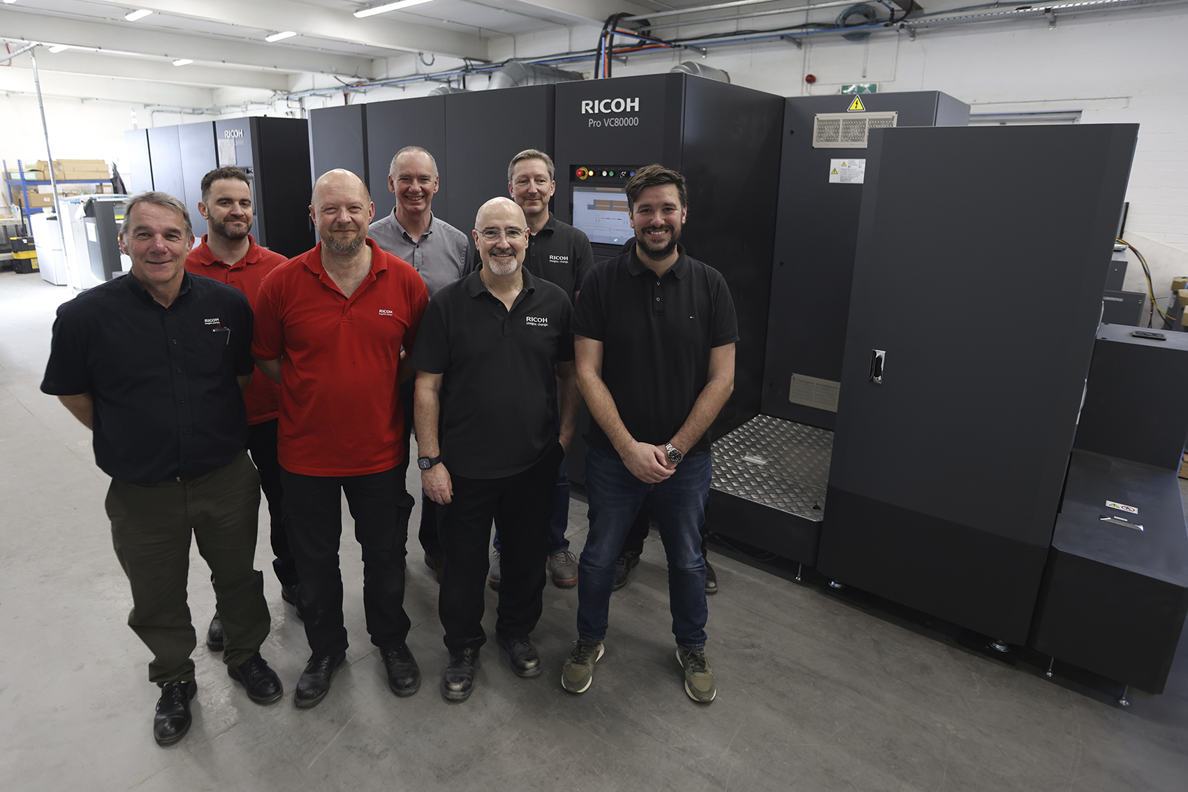 Solopress' Jack Clifford and a group of Ricoh engineers during the installation of Ricoh Pro VC80000